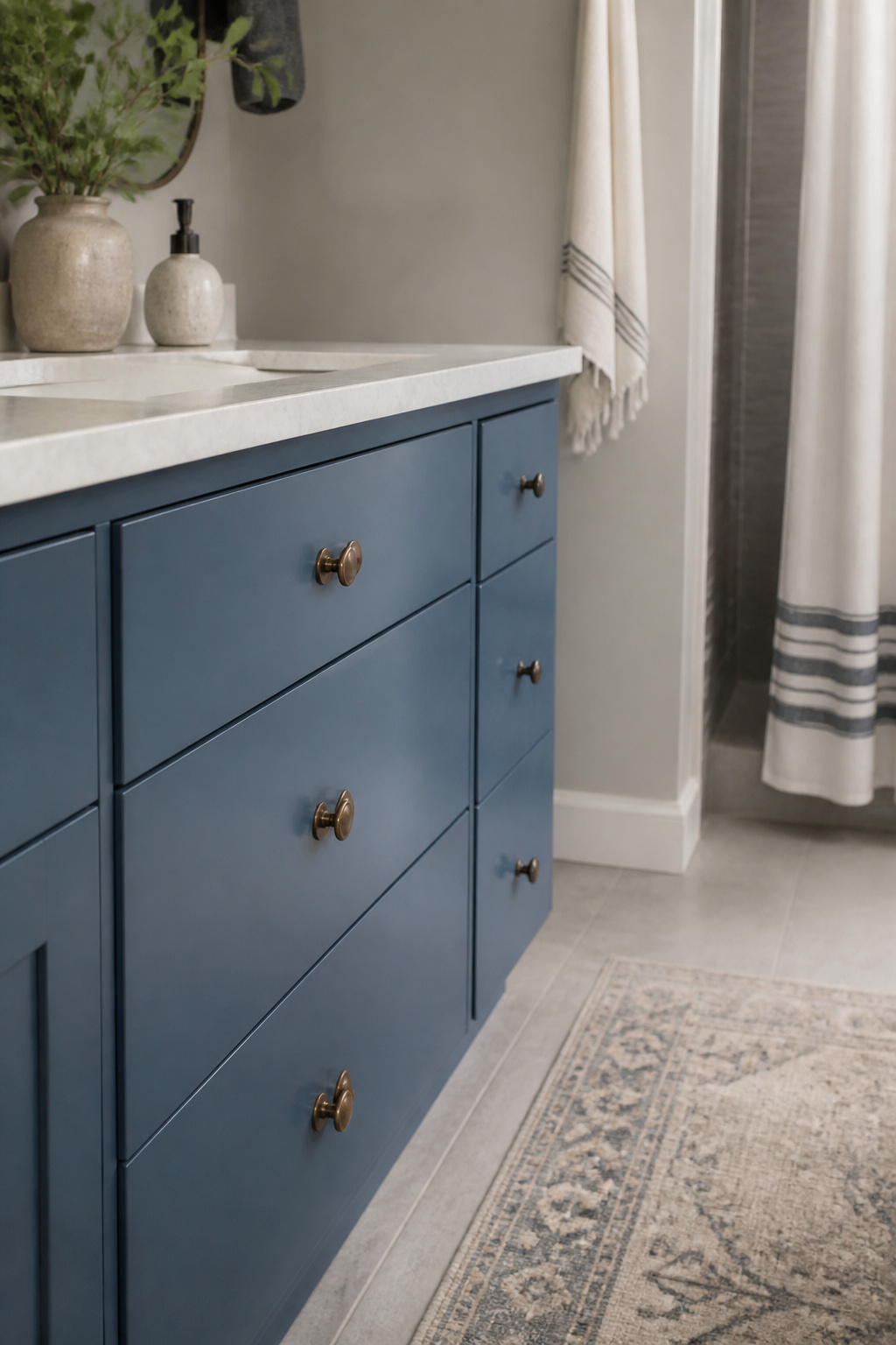 Standard Builder Grade Bathroom Light to Modern Farmhouse Makeover 4 New vintage bronze knobs on a blue farmhouse vanity.
